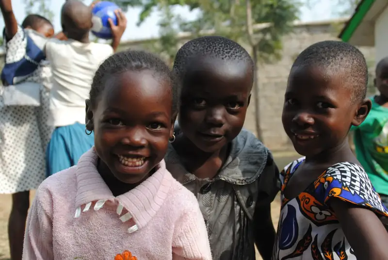 Three girls laughing into the camera at a CarePoint