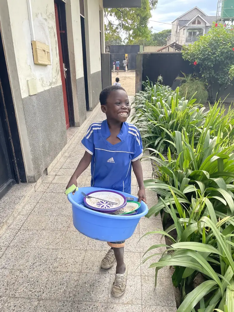 A child carrying a meal at a CarePoint