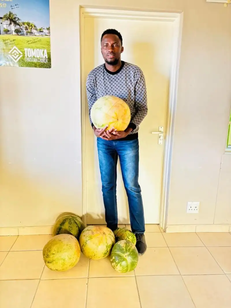 A member of the Oshikuku team with melons and mahangu given by children's parents